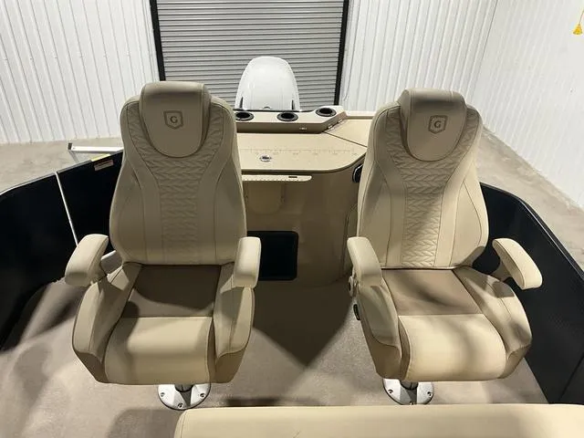 Slide: The Image of 2022 Godfrey Monaco 235 FS boat interior with two beige captain chairs. - 12