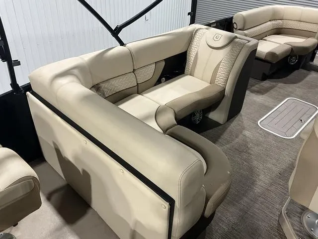 Slide: The Image of Luxurious seating on 2022 Godfrey Monaco 235 FS pontoon boat, featuring beige upholstery. - 13