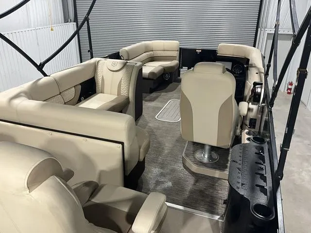 Slide: The Image of 2022 Godfrey Monaco 235 FS pontoon boat interior with beige seating and modern design. - 16