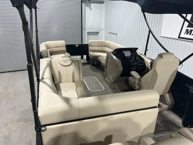 Slide: The Image of 2022 Godfrey Monaco 235 FS pontoon boat interior with beige seating and modern helm. - 17