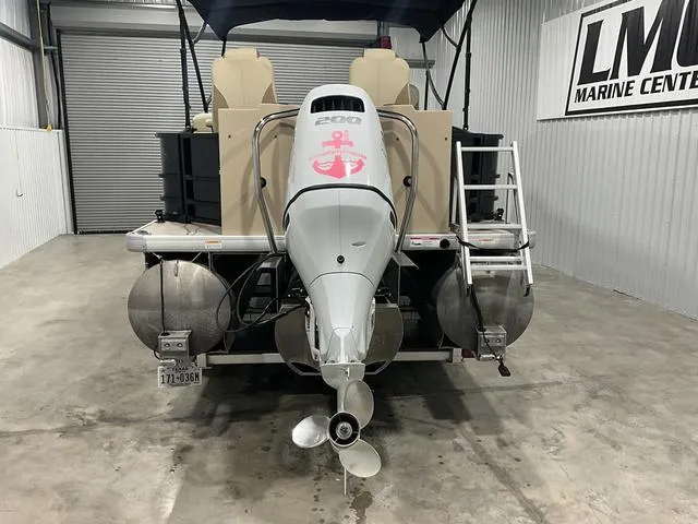 Slide: The Image of 2022 Godfrey Monaco 235 FS pontoon boat with outboard motor in a marine center. - 3