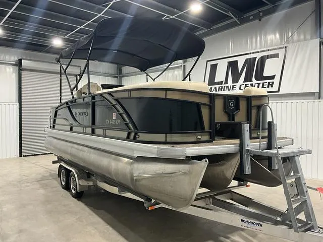 Slide: The Image of 2022 Godfrey Monaco 235 FS pontoon boat on trailer in a marine center. - 4