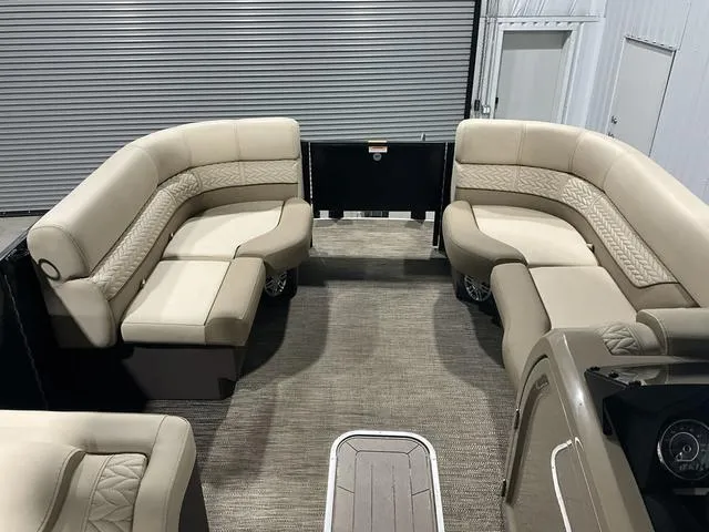 Slide: The Image of 2022 Godfrey Monaco 235 FS boat interior with beige seating and carpeted flooring. - 6