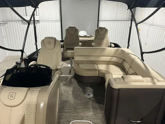 Slide: The Image of 2022 Godfrey Monaco 235 FS boat interior with beige seating and modern design. - 8