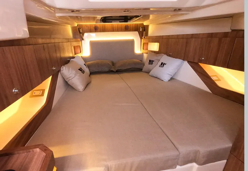 Slide: The Image of Luxurious cabin interior of 2026 Tiger Marine Maxline 38 with ambient lighting and cozy bedding. - 5
