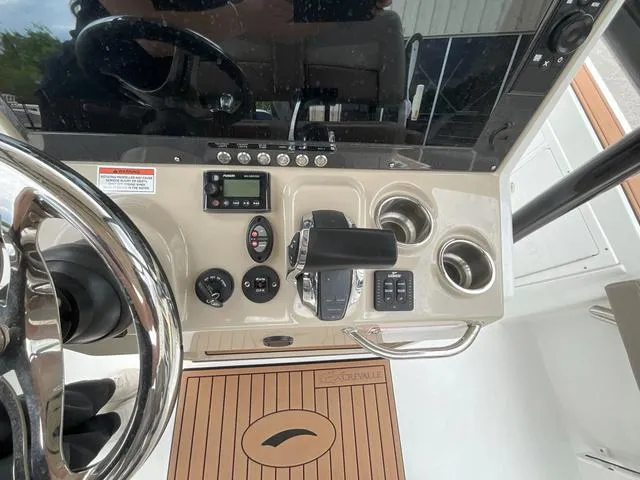 Slide: The Image of Control panel of 2020 Crevalle 260HCO boat with steering wheel and dashboard instruments. - 12