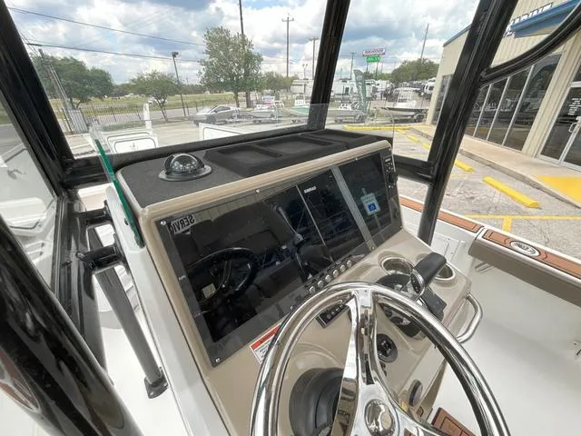Slide: The Image of 2020 Crevalle 260HCO boat dashboard with steering wheel and navigation display. - 13
