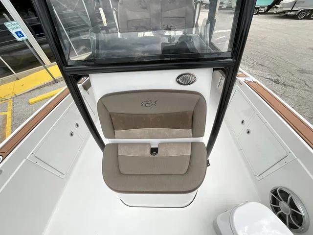 Slide: The Image of 2020 Crevalle 260HCO boat interior with cushioned seating and storage compartments. - 14