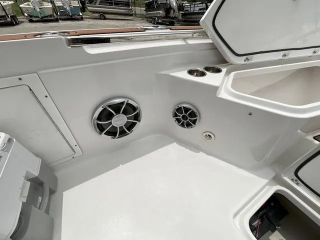 Slide: The Image of 2020 Crevalle 260HCO boat interior with speakers and storage compartments. - 16