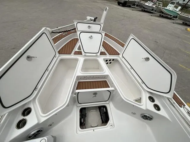 Slide: The Image of 2020 Crevalle 260HCO boat with open storage compartments and teak flooring. - 17