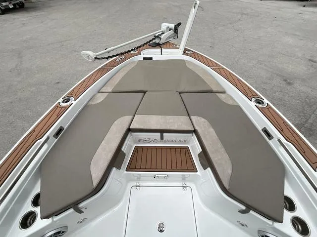 Slide: The Image of 2020 Crevalle 260HCO boat deck with cushioned seating and wood accents. - 18