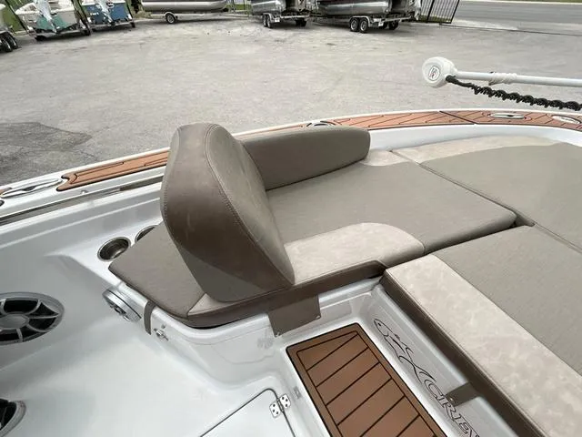 Slide: The Image of 2020 Crevalle 260HCO boat with cushioned seating and teak accents. - 20