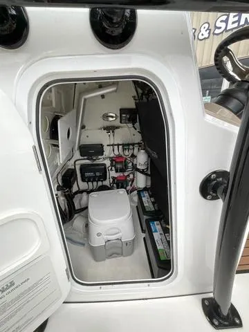 Slide: The Image of 2020 Crevalle 260HCO boat interior with equipment and storage area. - 21