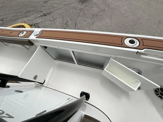 Slide: The Image of 2020 Crevalle 260HCO boat interior with open storage compartments and sleek design. - 22