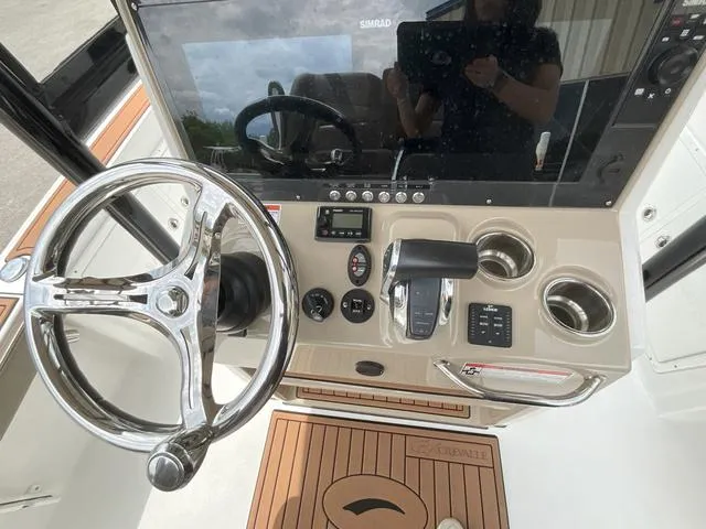 Slide: The Image of 2020 Crevalle 260HCO boat dashboard with steering wheel and control panel. - 23