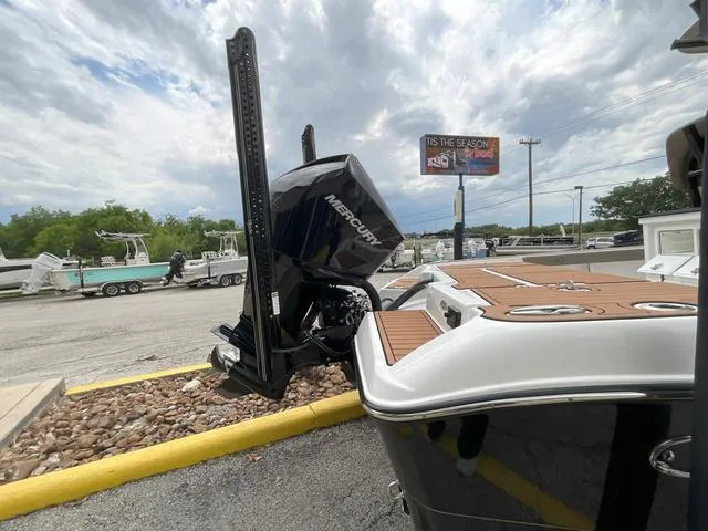 Slide: The Image of 2020 Crevalle 260HCO boat with Mercury engine, parked outdoors on a cloudy day. - 26