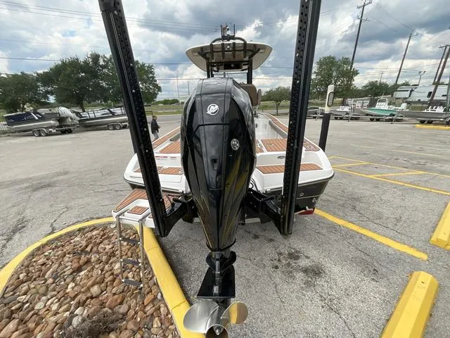 Slide: The Image of 2020 Crevalle 260HCO boat with powerful outboard motor in a parking lot. - 27