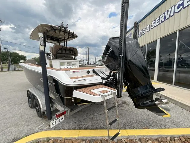 Slide: The Image of 2020 Crevalle 260HCO boat with powerful outboard motor, parked near service center. - 29