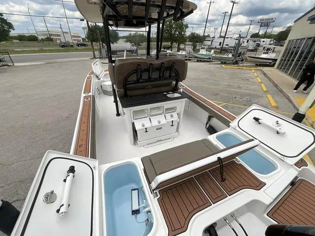 Slide: The Image of 2020 Crevalle 260HCO boat interior with seating, storage, and fishing rod holders. - 5