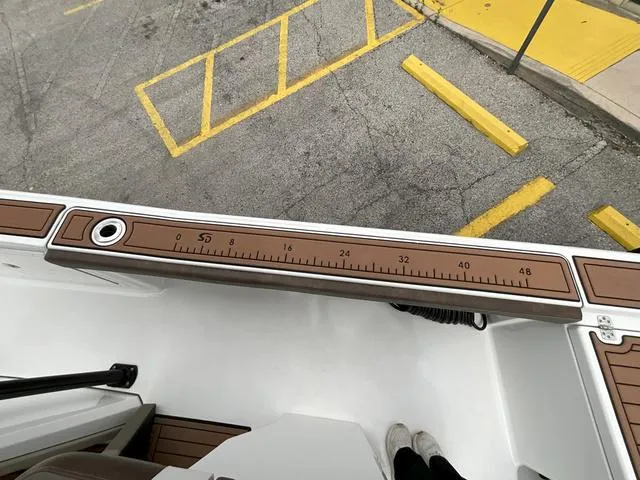 Slide: The Image of 2020 Crevalle 260HCO boat with measuring ruler on deck, parked in lot. - 8