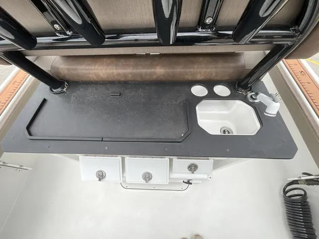 Slide: The Image of 2020 Crevalle 260HCO boat console with sink and storage compartments. - 9