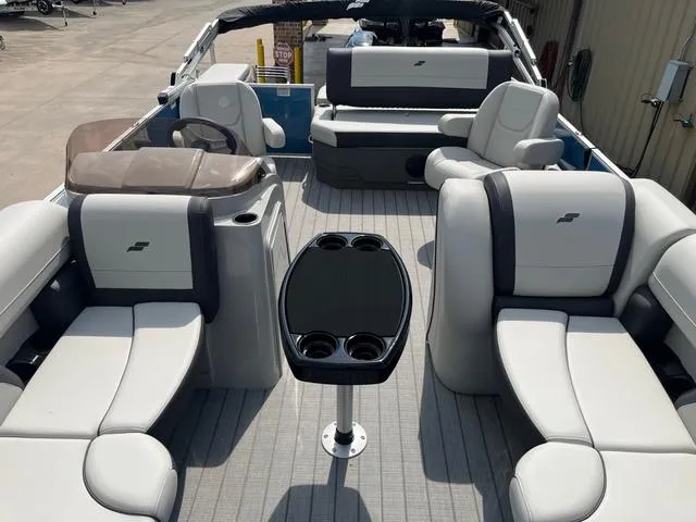 Slide: The Image of 2025 Starcraft EX20QDH pontoon boat interior with plush seating and central table. - 10