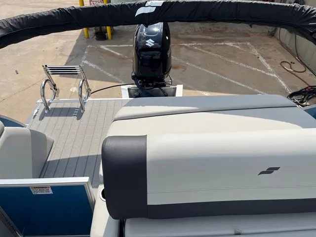 Slide: The Image of 2025 Starcraft EX20QDH boat with outboard motor and seating, docked on concrete surface. - 11