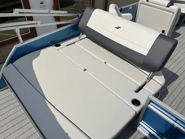 Slide: The Image of 2025 Starcraft EX20QDH boat interior with cushioned seating and cup holders. - 12