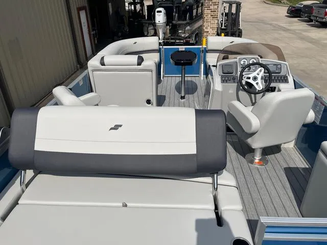 Slide: The Image of 2025 Starcraft EX20QDH boat interior with modern seating and steering console. - 13