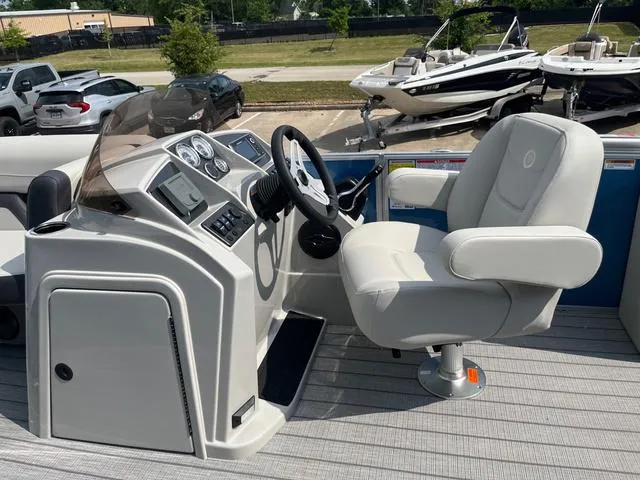 Slide: The Image of 2025 Starcraft EX20QDH boat helm with steering wheel and captain's chair. - 20