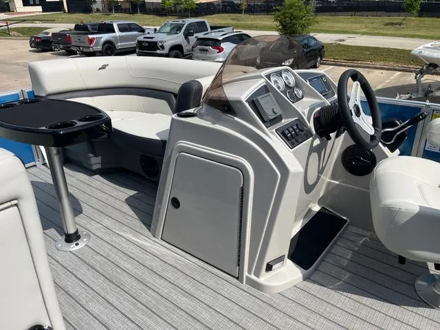 Slide: The Image of 2025 Starcraft EX20QDH boat interior with steering console and seating area. - 21