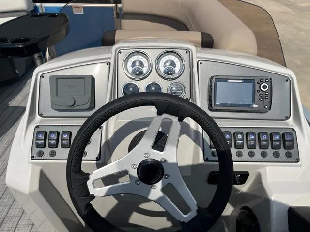 Slide: The Image of Steering console of 2025 Starcraft EX20QDH boat with gauges and navigation system. - 22