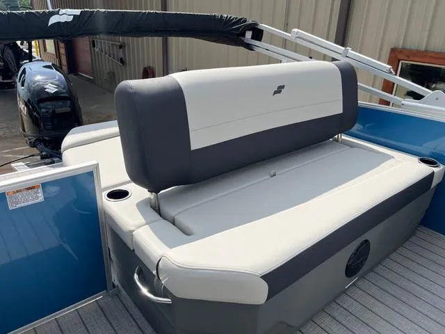 Slide: The Image of 2025 Starcraft EX20QDH boat interior with cushioned seating and cup holders. - 24