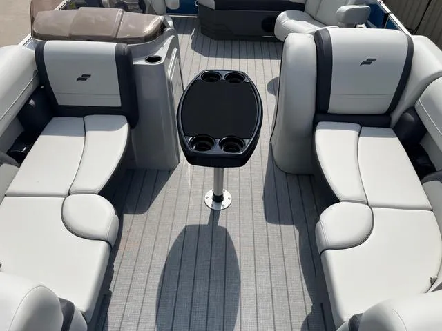 Slide: The Image of 2025 Starcraft EX20QDH boat interior with gray seating and central table. - 9