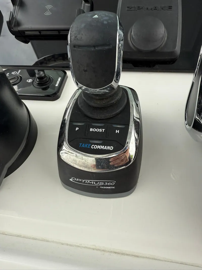 Slide: The Image of Optimus 360 joystick control on 2025 Stingray 273 CC boat dashboard. - 14