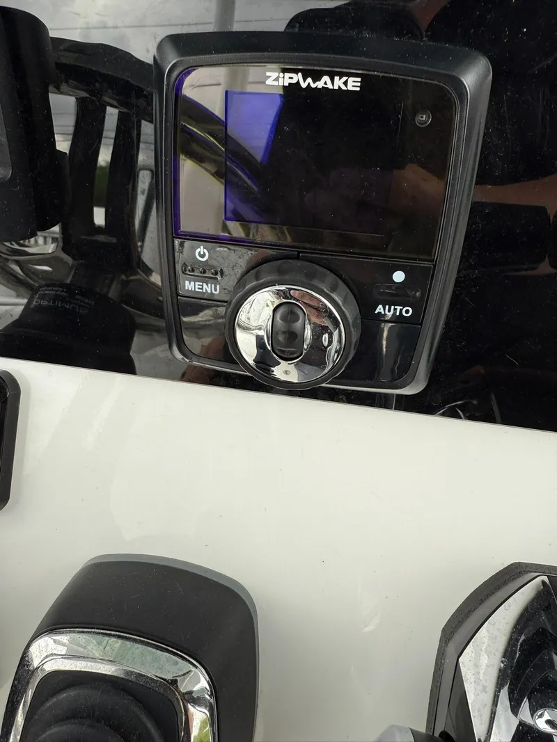 Slide: The Image of Zipwake control panel on 2025 Stingray 273 CC boat dashboard. - 15