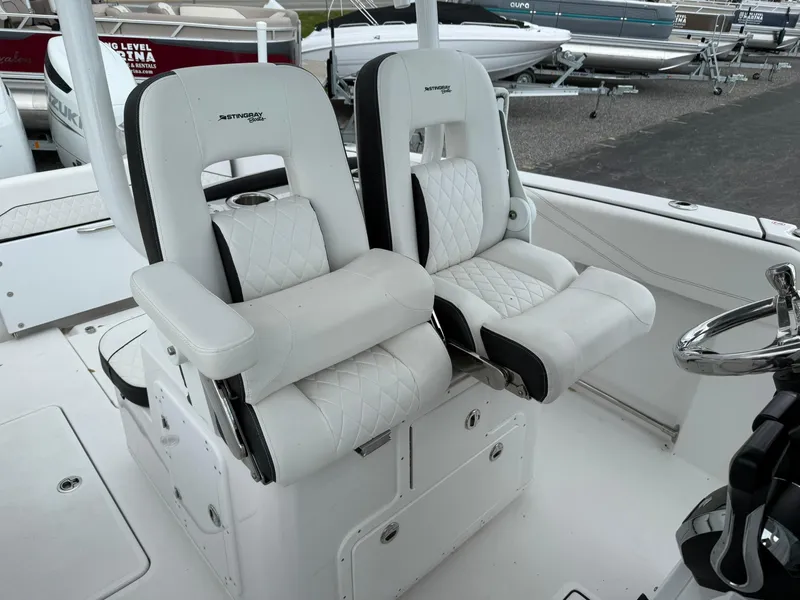 Slide: The Image of 2025 Stingray 273 CC boat with luxurious white seating and modern design. - 18