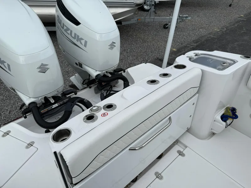 Slide: The Image of 2025 Stingray 273 CC boat with dual Suzuki outboard motors and sleek seating area. - 20