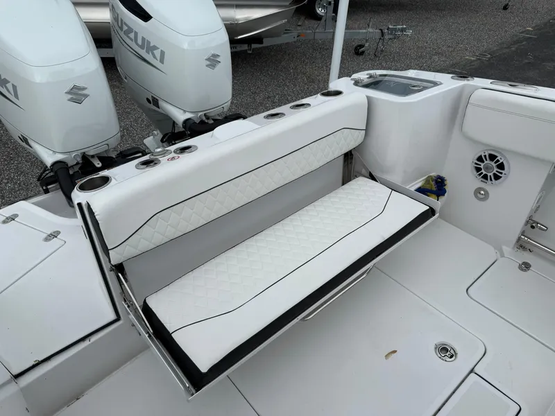 Slide: The Image of 2025 Stingray 273 CC boat interior with white seating and dual Suzuki engines. - 21