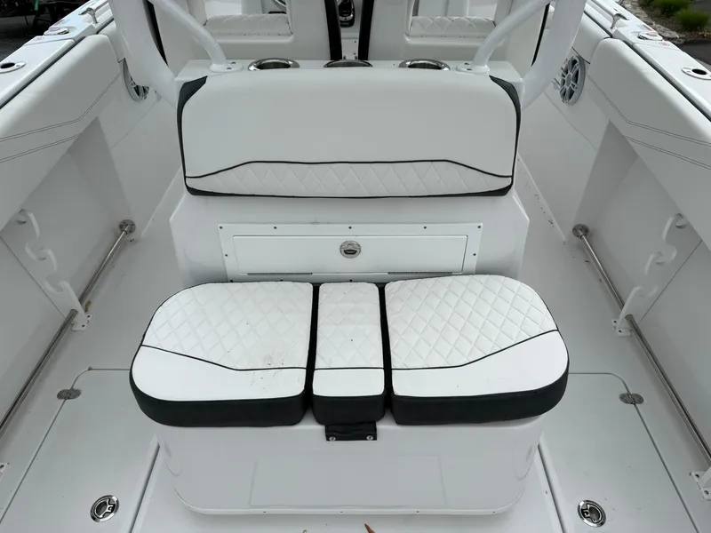Slide: The Image of 2025 Stingray 273 CC boat interior with white cushioned seating and sleek design. - 22