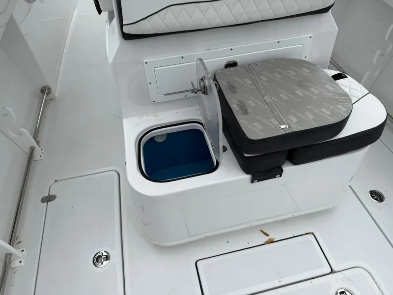 Slide: The Image of 2025 Stingray 273 CC boat interior with seating and storage compartments. - 23