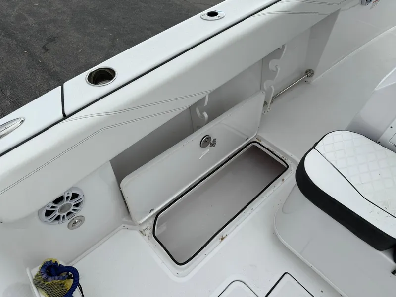 Slide: The Image of 2025 Stingray 273 CC boat interior with storage compartment and seating. - 24
