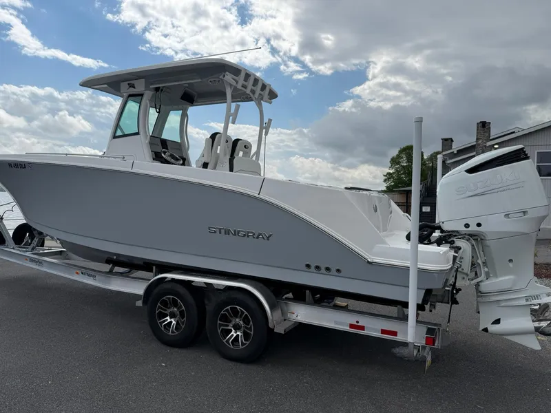 Slide: The Image of 2025 Stingray 273 CC boat on trailer, under cloudy sky. - 3