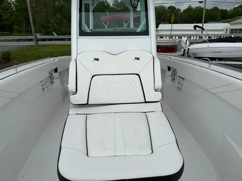 Slide: The Image of 2025 Stingray 273 CC boat interior with white cushioned seating. - 31