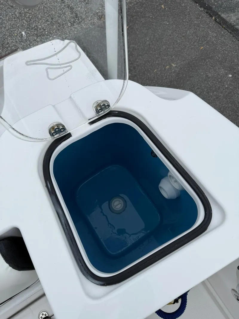 Slide: The Image of 2025 Stingray 273 CC boat livewell with open lid, showcasing interior design. - 36