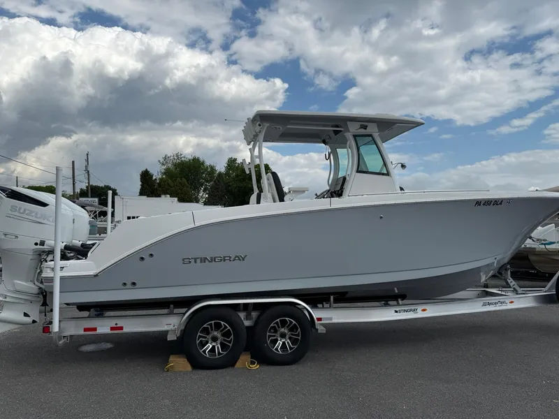 Slide: The Image of 2025 Stingray 273 CC boat on trailer under cloudy sky. - 6