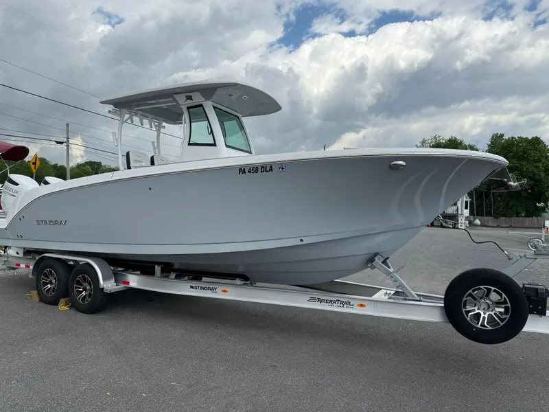 Slide: The Image of 2025 Stingray 273 CC boat on trailer under cloudy sky. - 7