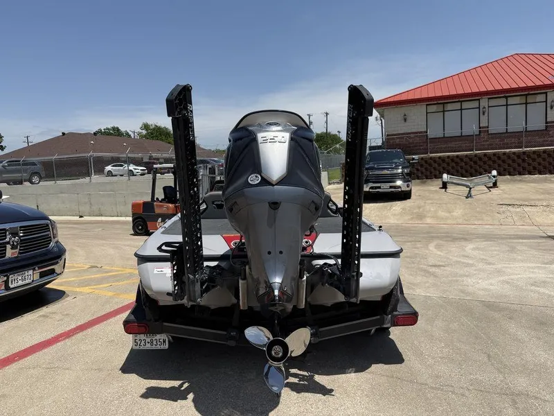Slide: The Image of 2023 Skeeter FXR21 Limited boat with powerful outboard motor, parked in a lot. - 10