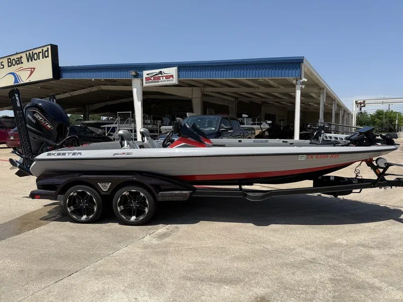 Slide: The Image of 2023 Skeeter FXR21 Limited boat on trailer at dealership, side view. - 15