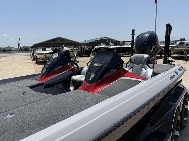 Slide: The Image of 2023 Skeeter FXR21 Limited boat with dual consoles and Yamaha engine, parked outdoors. - 4